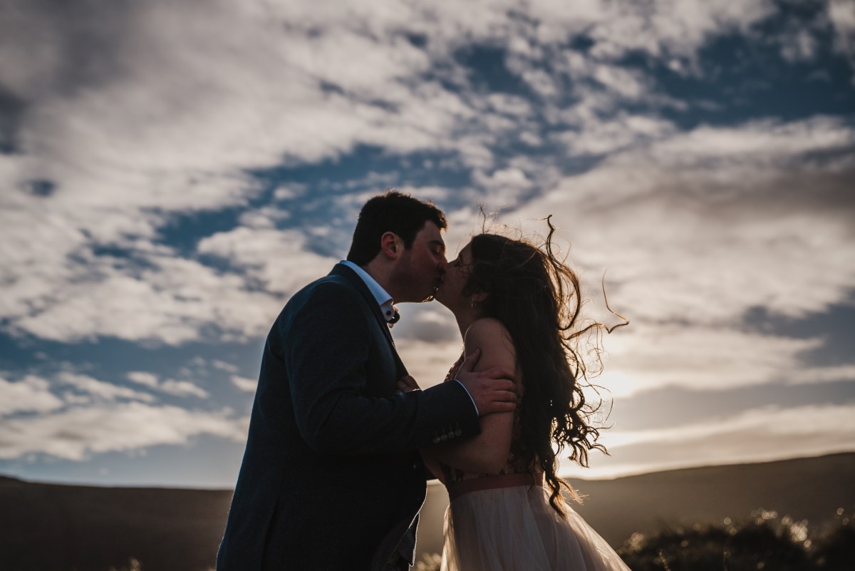 Conor and Victoria of Bello Duo embracing at golden hour