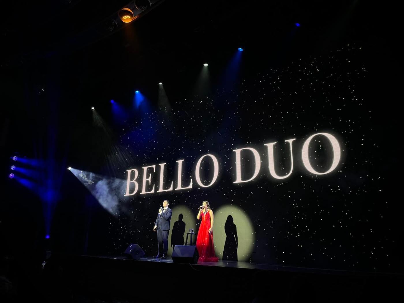 Bello Duo name on a concert stage screen